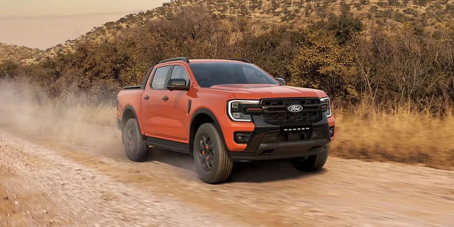 Red Ford Ranger driving on rocky terrain — Next Level Ranger gallery